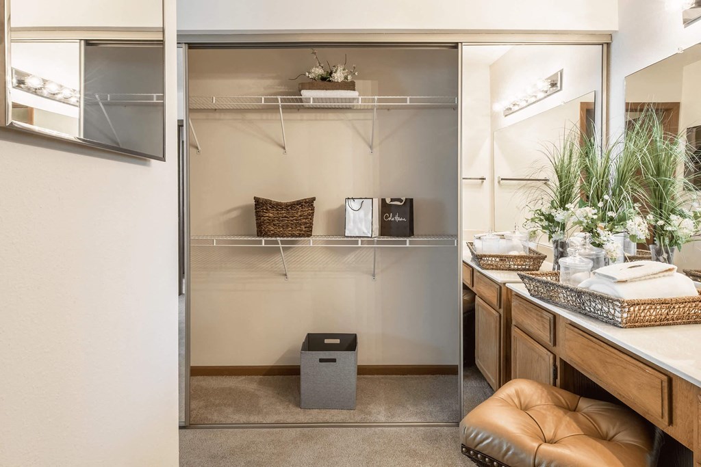 a small bathroom with a shower and a counter with a sink and a mirror