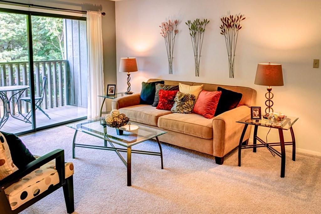 a living room with a couch and a glass table