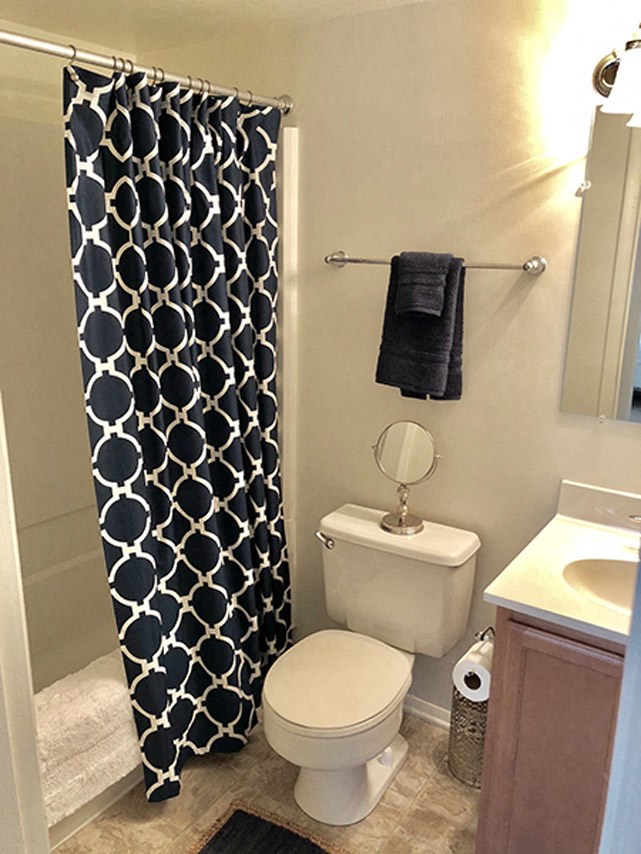 a bathroom with a toilet and a shower curtain