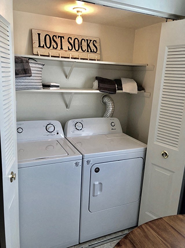 a closet with two washers and a dryer in a laundry room