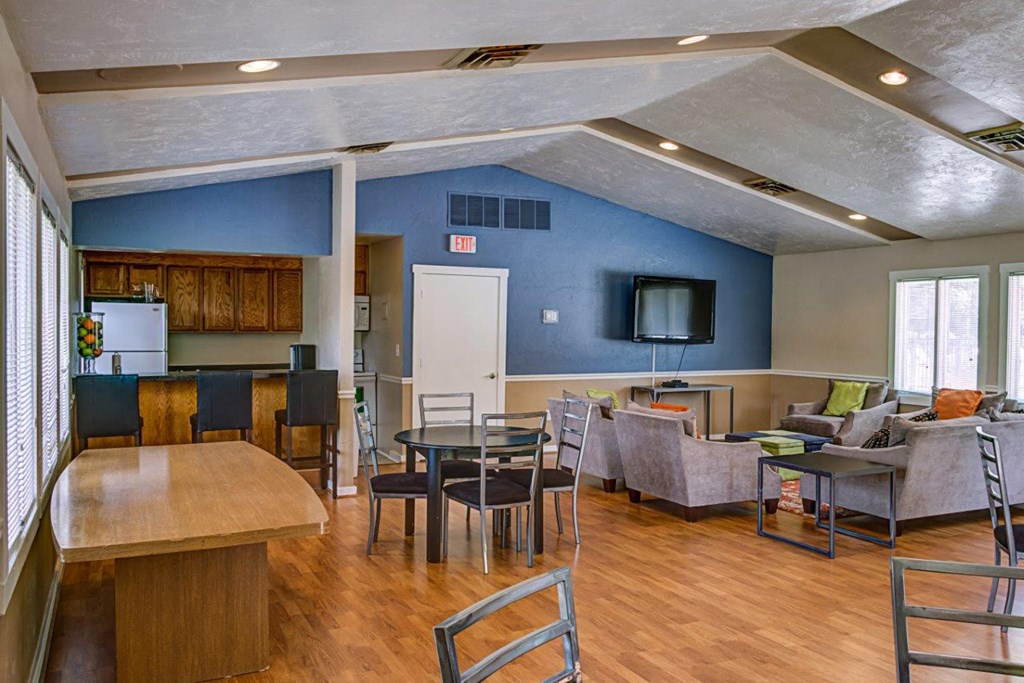 a living room and dining room with a table and chairs