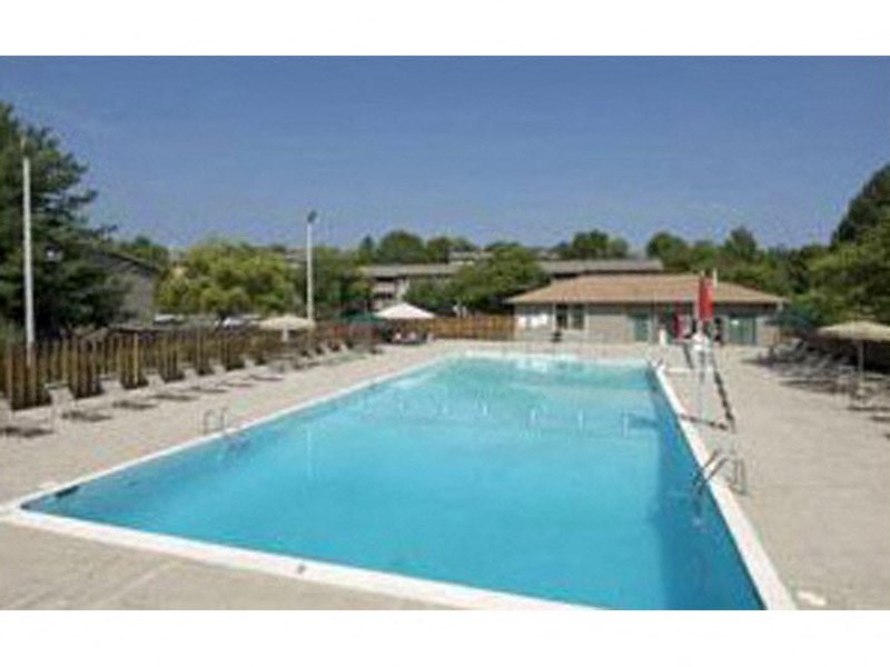 a large swimming pool in front of a building