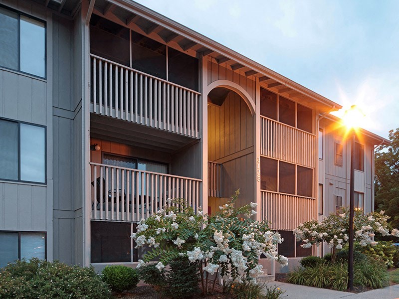 an exterior view of a building with flowering plants