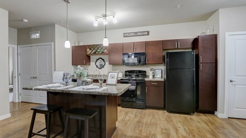 A kitchen with a table set for two and a sign that says "Follow-up Dreams.".