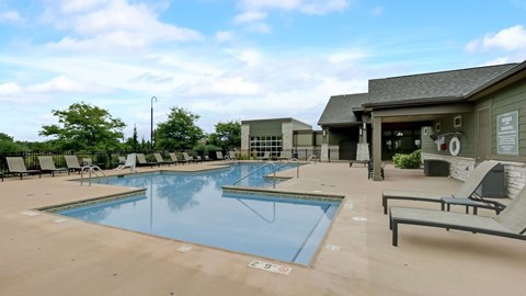 Resort style pool with lounge chairs and clubhouse at Reserve at Romeoville, Romeoville, IL