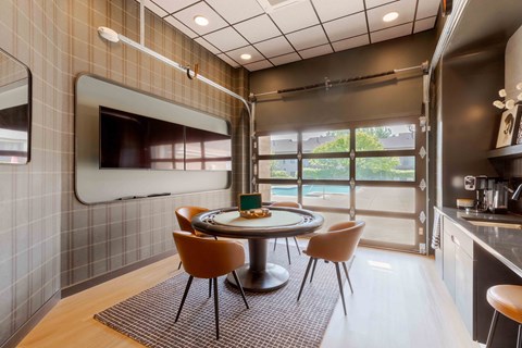 A modern kitchen with a dining table and chairs.