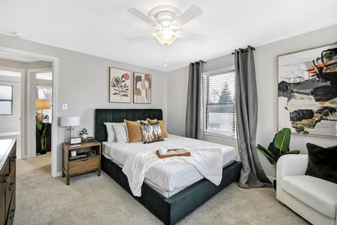a bedroom with a bed and a ceiling fan