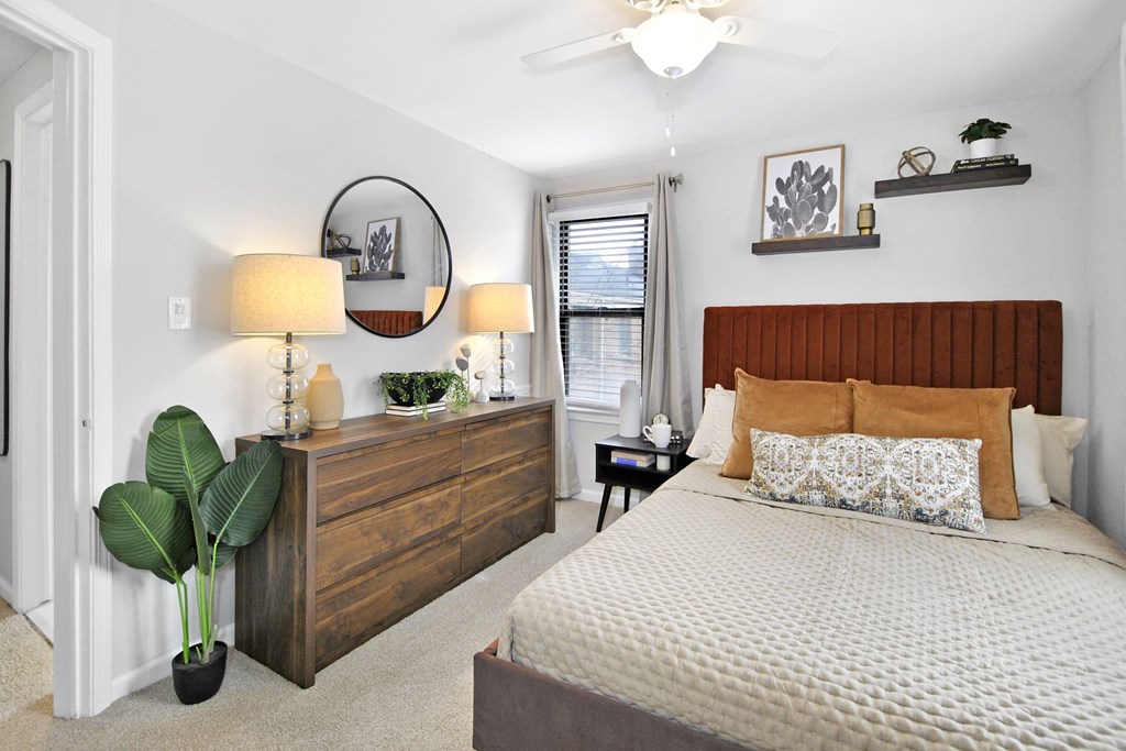 a bedroom with a bed and a dresser