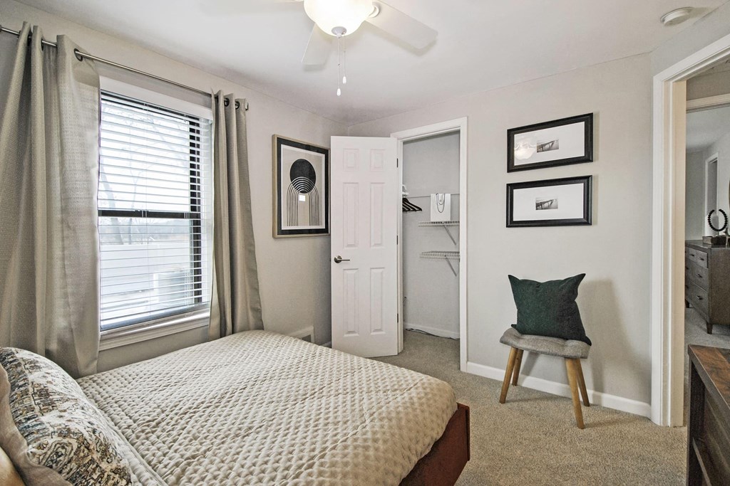 a bedroom with a bed and a door to a bathroom