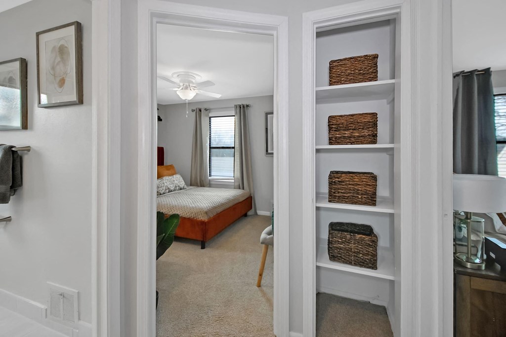 a bedroom with a bed and a closet with shelves