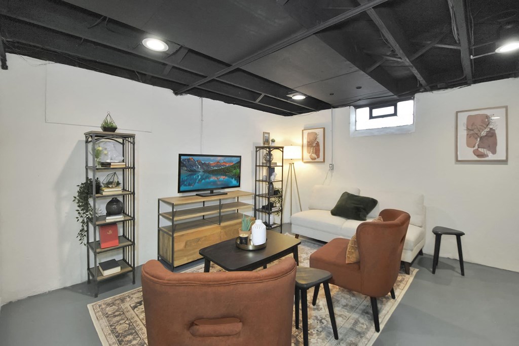 a living room with a white couch and a tv