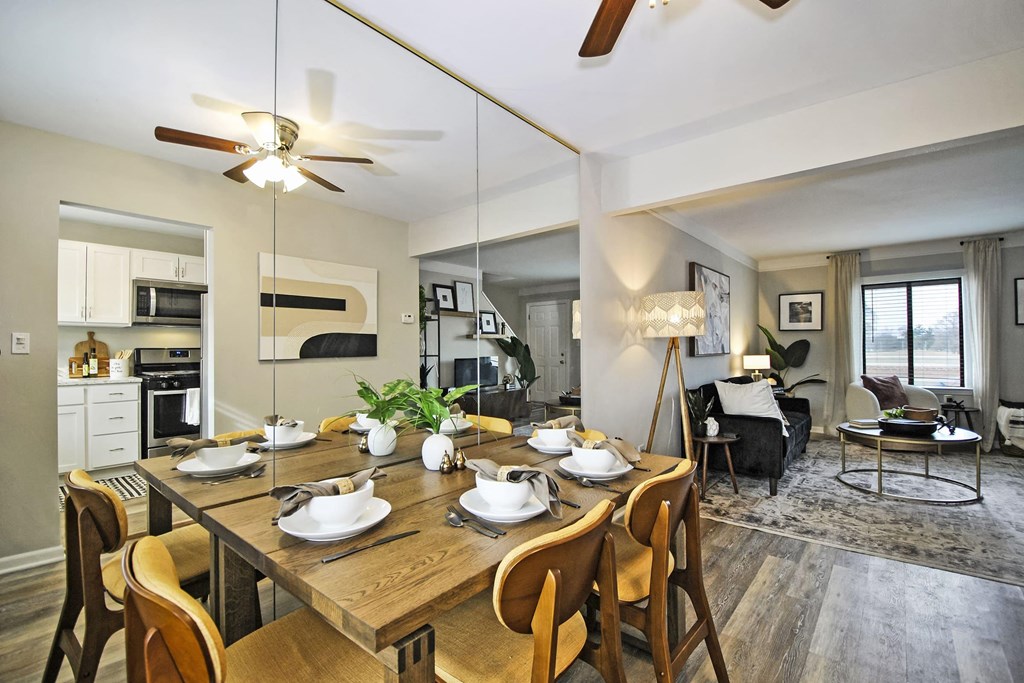 a dining room table with chairs next to a living room