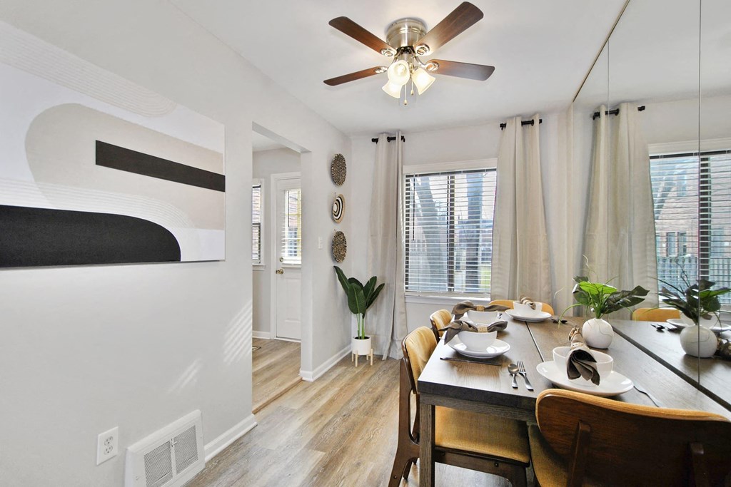 a dining room with a table and a ceiling fan