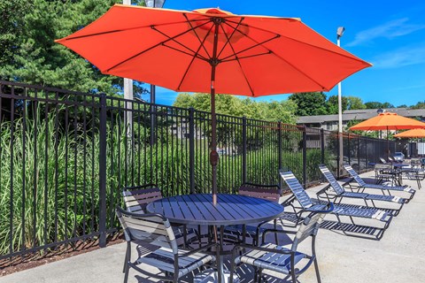 a patio with a table and chairs and an umbrella
