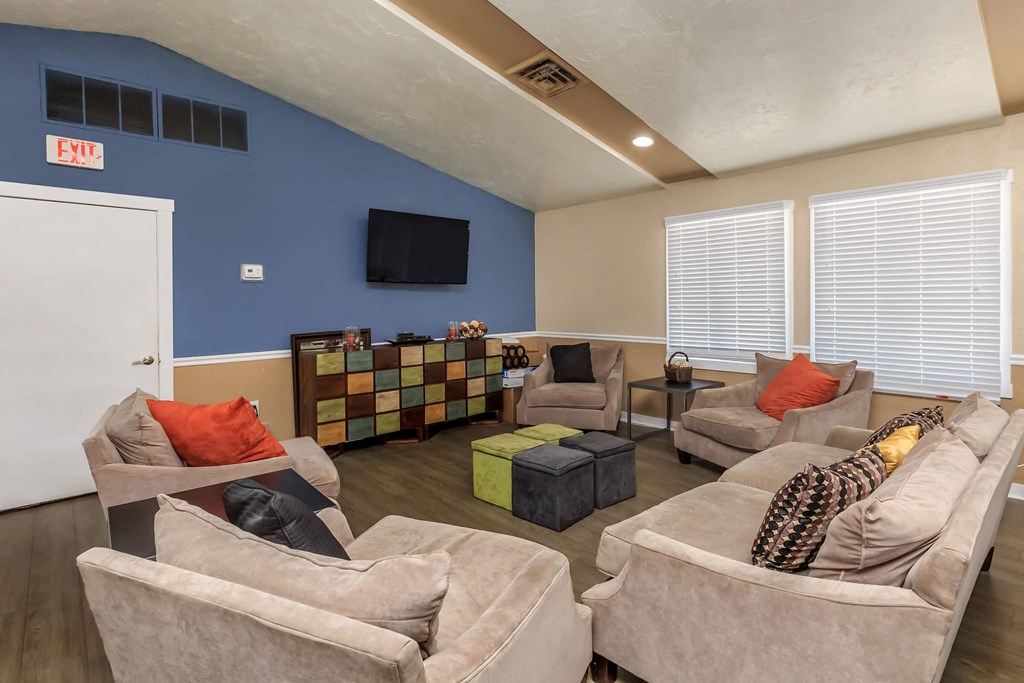 a living room with couches and chairs and a tv