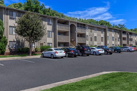 an apartment building with cars parked in front of it