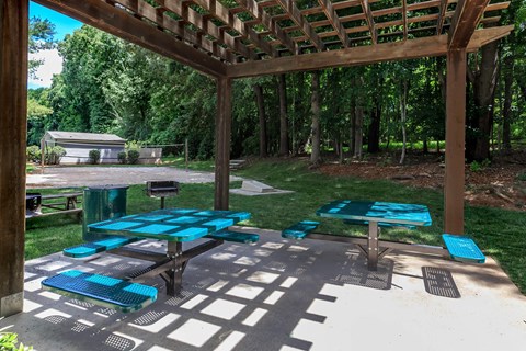 a group of picnic tables under a covered pavilion