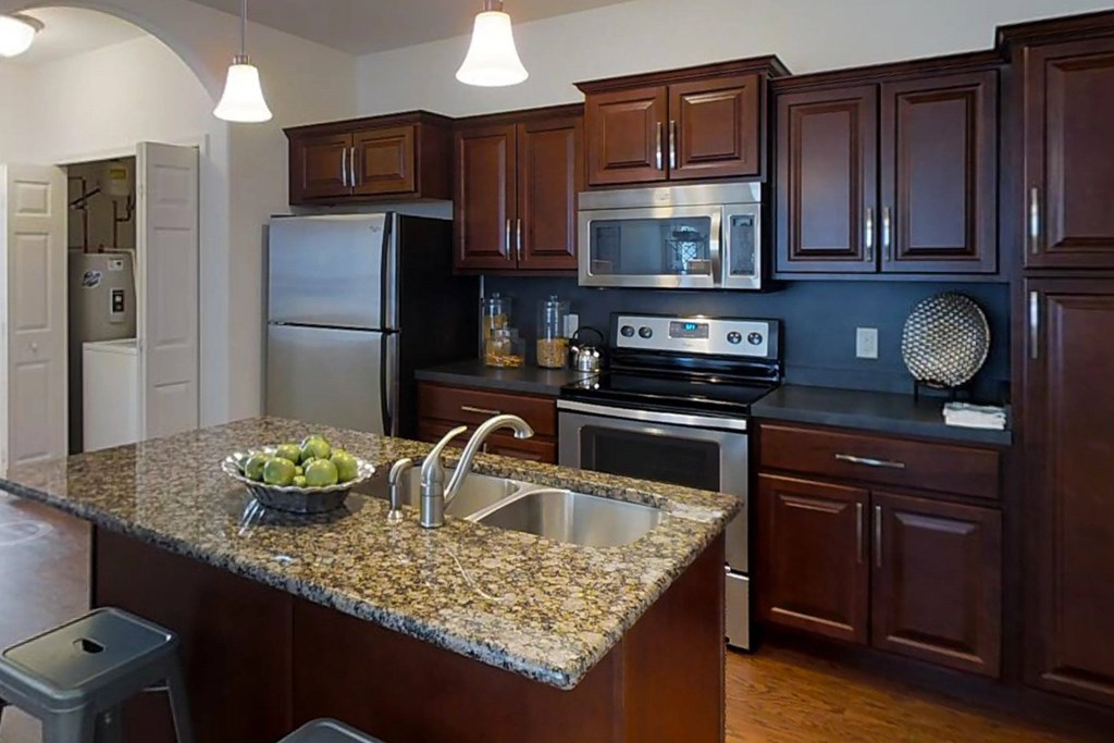 A kitchen with granite countertops and stainless steel appliances.at Meridian West Shore, Mechanicsburg, PA 17055