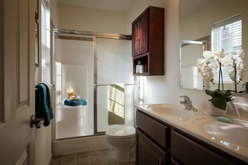 A bathroom with a toilet, sink, and shower.at Meridian West Shore, Pennsylvania