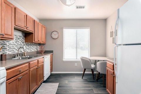 A kitchen with wooden cabinets and a white refrigerator.