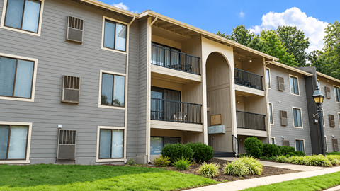 Apartment building with a balcony on the second floor.