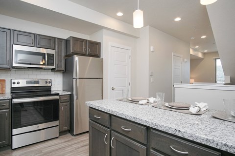 Modern kitchen with granite countertops at Liberty Point Apartments, Utah