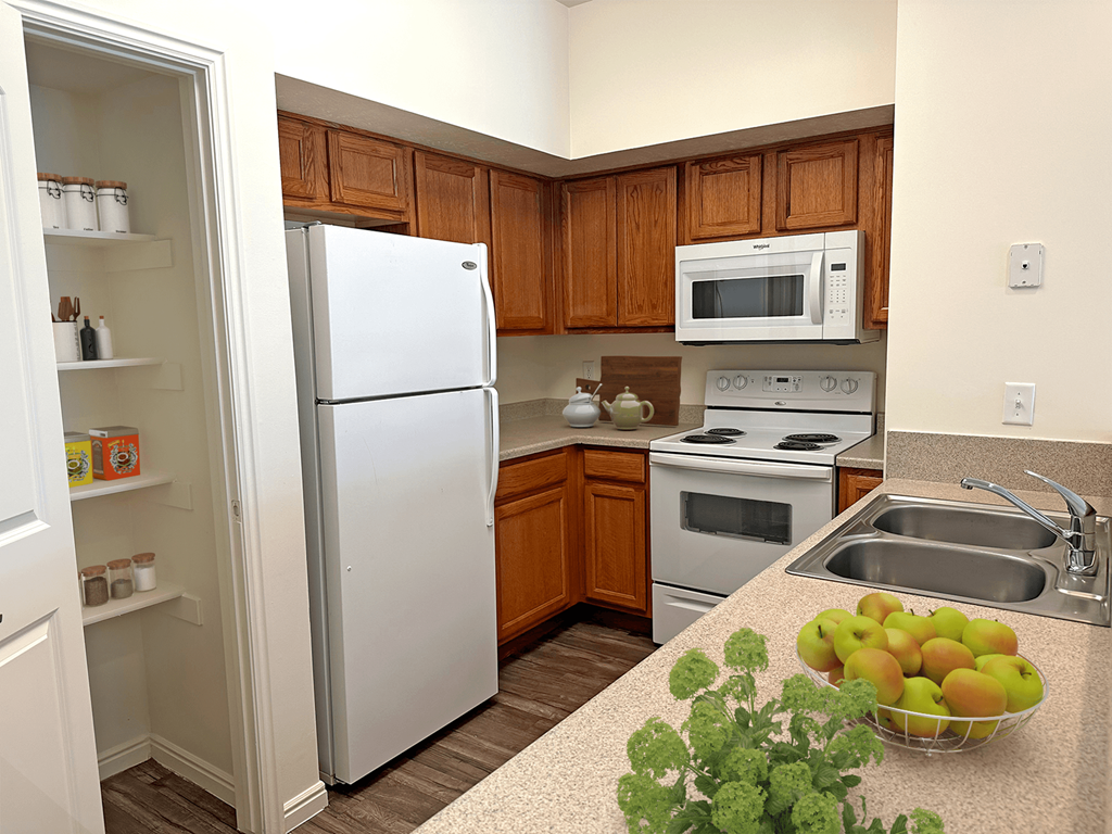 Liberty Landing Apartments Heathrow Floor Plan Kitchen with pantry, refrigerator, stove and sink. West Jordan, Utah.