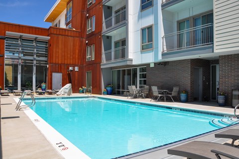 Resort style pool with lounge seating at Liberty Blvd Apartments, Utah