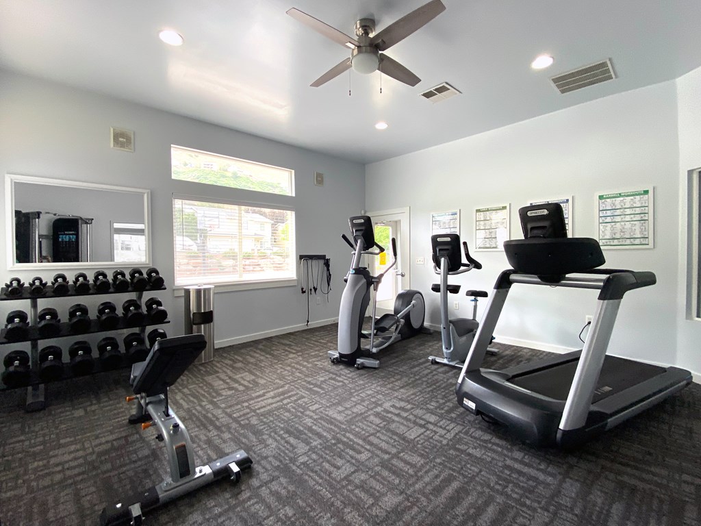 Liberty Hill Apartments, Draper, Utah, spacious gym with a variety of equipment including treadmills, weights, and exercise machines.