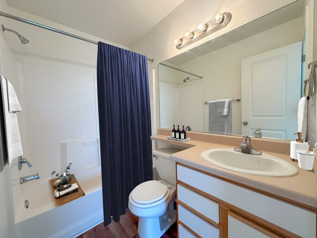 Liberty Hill Apartments, Draper, Utah, bathroom with a white sink and a blue shower curtain.