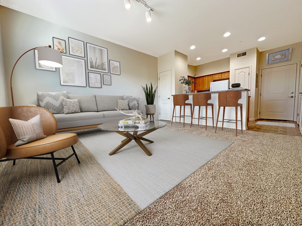 Liberty Bend Apartments, Sandy, Utah, living room with a couch and a table in front of a kitchen