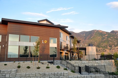 Modern apartment building with stone retaining walls at Liberty Point Apartments, Draper