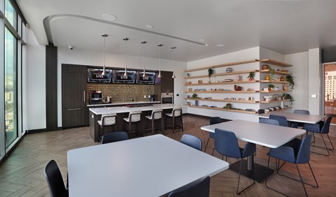 Community dining area with kitchen bar and open shelving at Liberty Sky Apartments, Salt Lake City