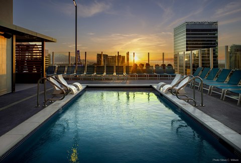 Rooftop pool with lounge chairs and sunset views at Liberty Sky Apartments, Utah