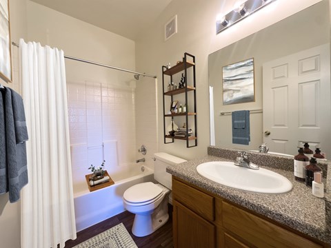 A bathroom with a white toilet and a white sink.