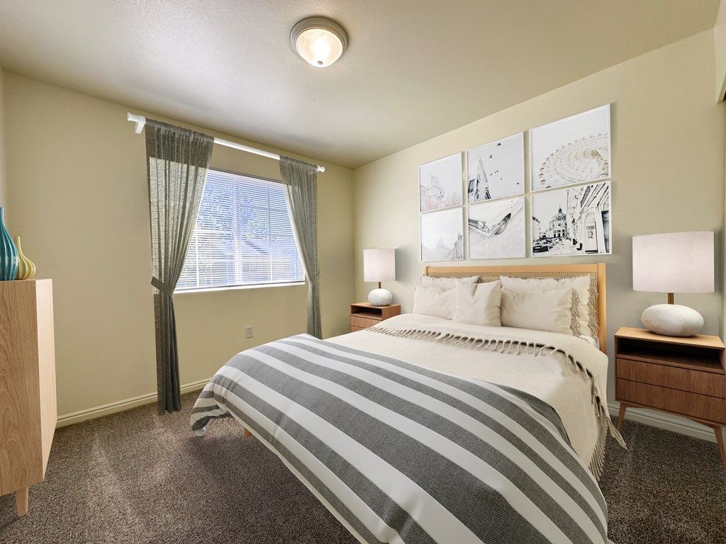 The Ridge at Jordan Landing Apartments, West Jordan, Utah, bedroom with wooden double bed, nightstands and lamps.