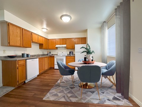 a kitchen and dining area with a table and chairs