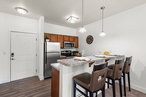 A kitchen with a table set for four.