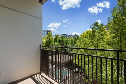 Balcony with metal railing overlooking trees at Liberty Gateway Apartments, Salt Lake City, 84101