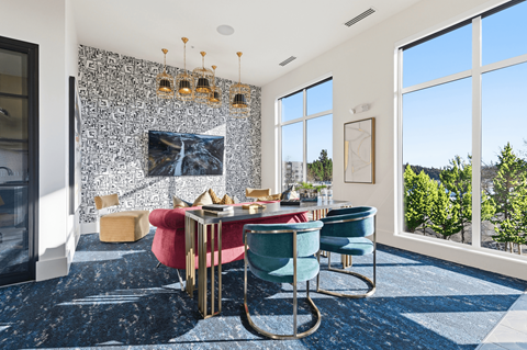 A dining room with a red table and blue chairs.