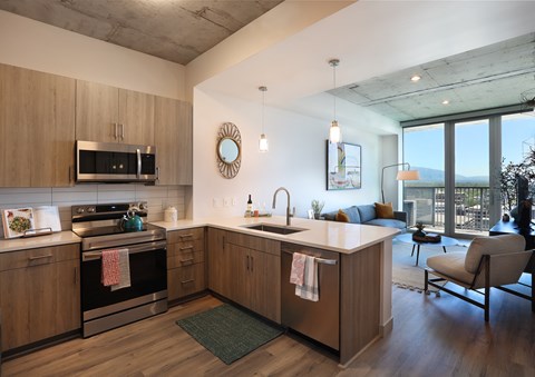Open kitchen with island and living area at Liberty Sky Apartments, Salt Lake City, UT 84111