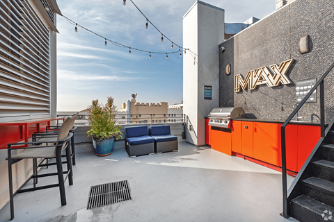 A rooftop patio with a MAX sign on the wall.