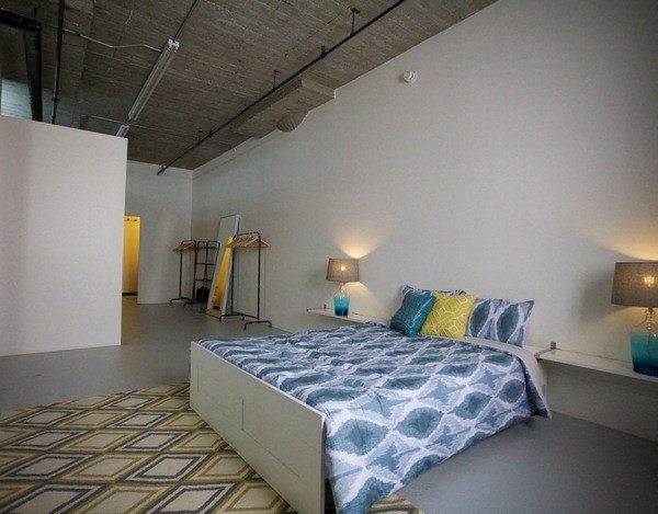 a bedroom with a bed in the middle at Binford Lofts Apartments, Los Angeles , CA, 90013