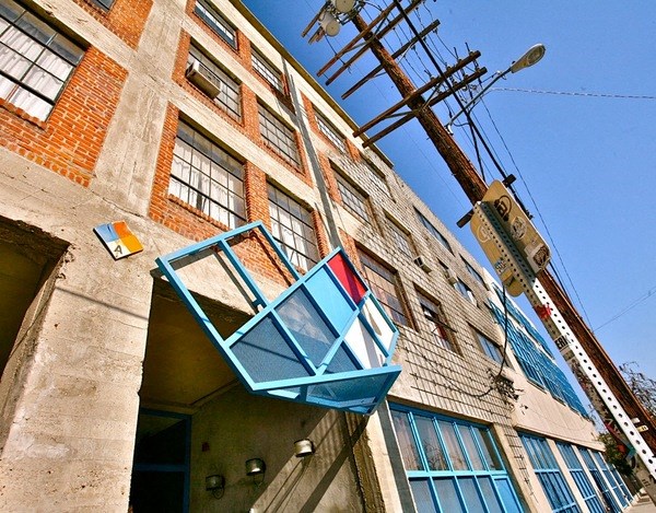 an old building with a window on the side of it at Binford Lofts Apartments, California