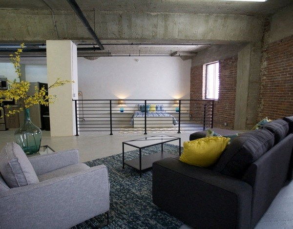 a living room with a couch and a coffee table at Binford Lofts Apartments, Los Angeles , California