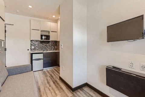 a living room with a television and a kitchen at Mikado Little Tokyo, Los Angeles, 90012