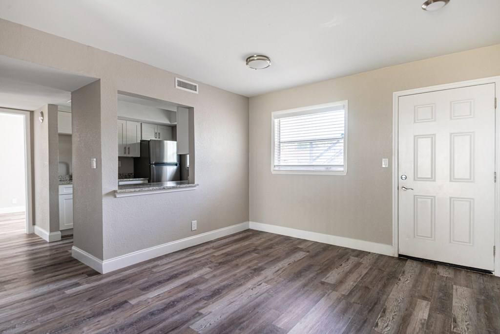 an empty living room with a door to a kitchen at Palm Cove Apartments, Florida, 32114