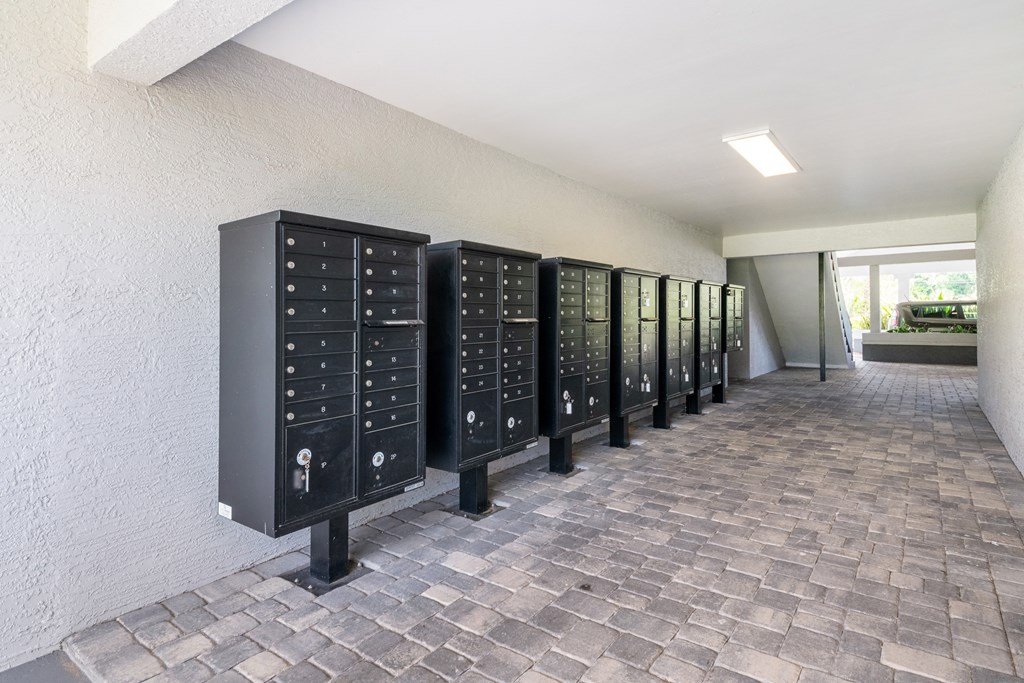a row of metal lockers in a room with a brick floor at Palm Cove Apartments, Daytona Beach, 32114