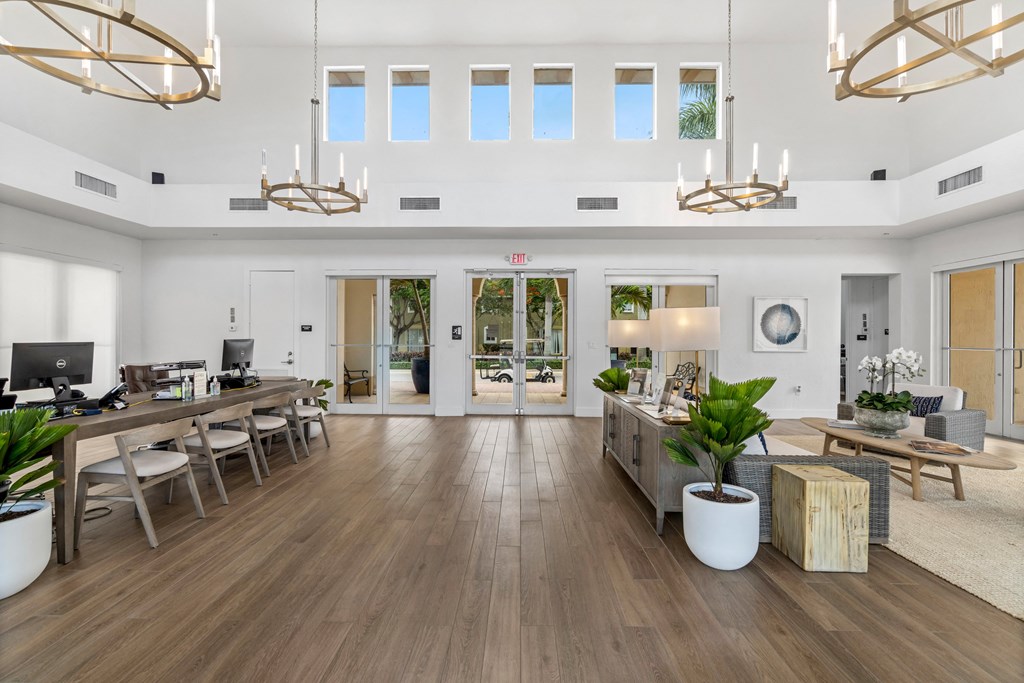 the living room has a large open floorplan with wood floors and white walls