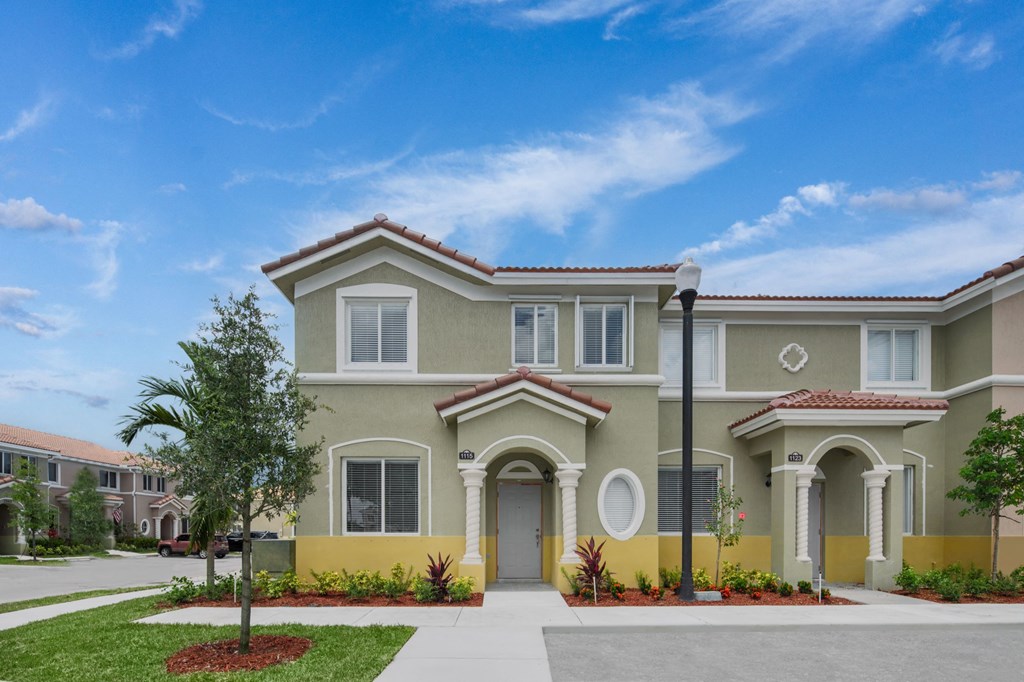 a large house with a sidewalk in front of it